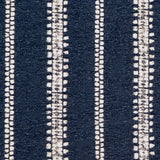 Detail of fabric in an irregular stripe print in white on an indigo field.
