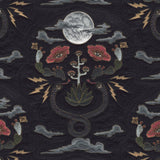 Detail of wallpaper in a playful snake, plant and moon print in shades of red, brown and gray.