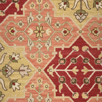 Decorative rug with geometric pattern in red, beige, and brown