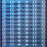 Handwoven rug in a Swedish arrow design in brown and white on a green field. 