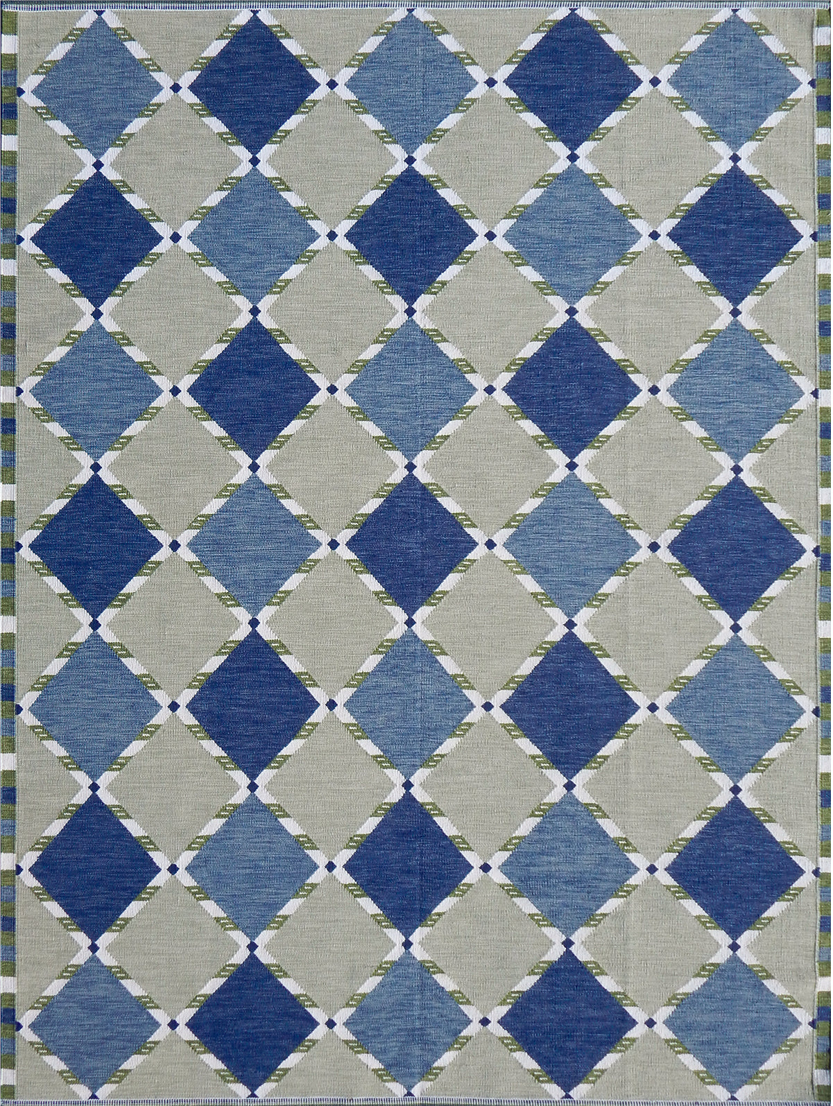 Handwoven rug in a Swedish diamond lattice design shades of green and blue with white accents. 