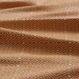 Close-up of yellow fabric with geometric pattern gently folded