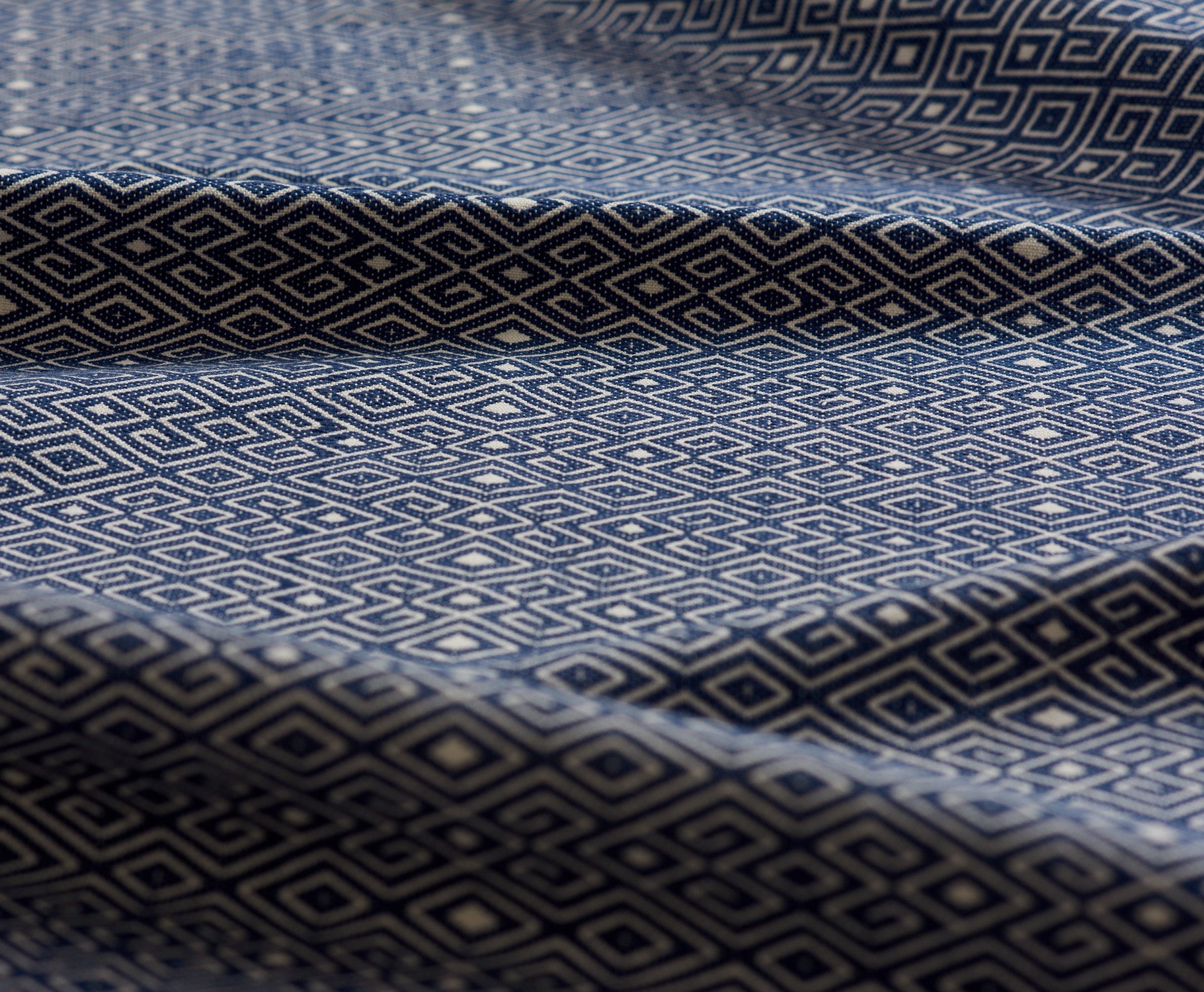 Close-up of blue and white patterned fabric lightly folded