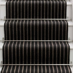 Striped flatweave runner in black and white on white staircase