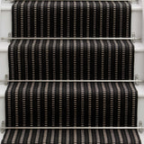 Striped flatweave runner in black and white on white staircase