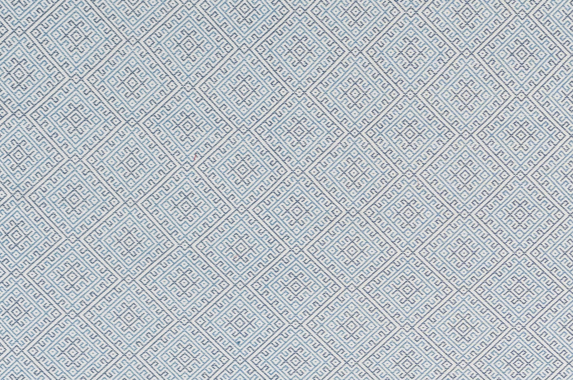 Textured fabric with a diamond pattern in blue on white. 