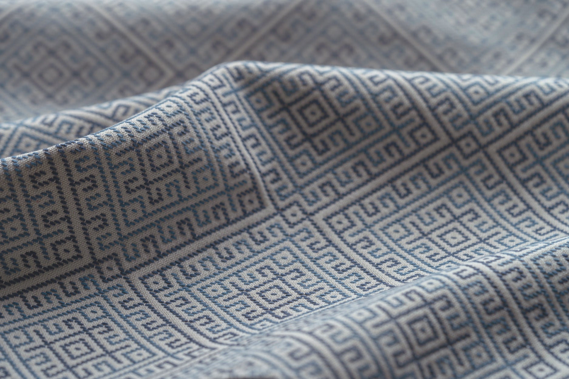 Close-up of textured fabric with geometric pattern in blue 
