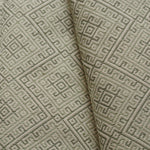 Close-up of textured beige fabric with geometric pattern