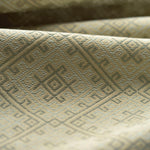 Close-up of textured green fabric with geometric pattern