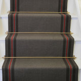 Striped flatweave runner in grey and red on white staircase