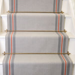 Striped flatweave runner in grey taupe and red on white staircase