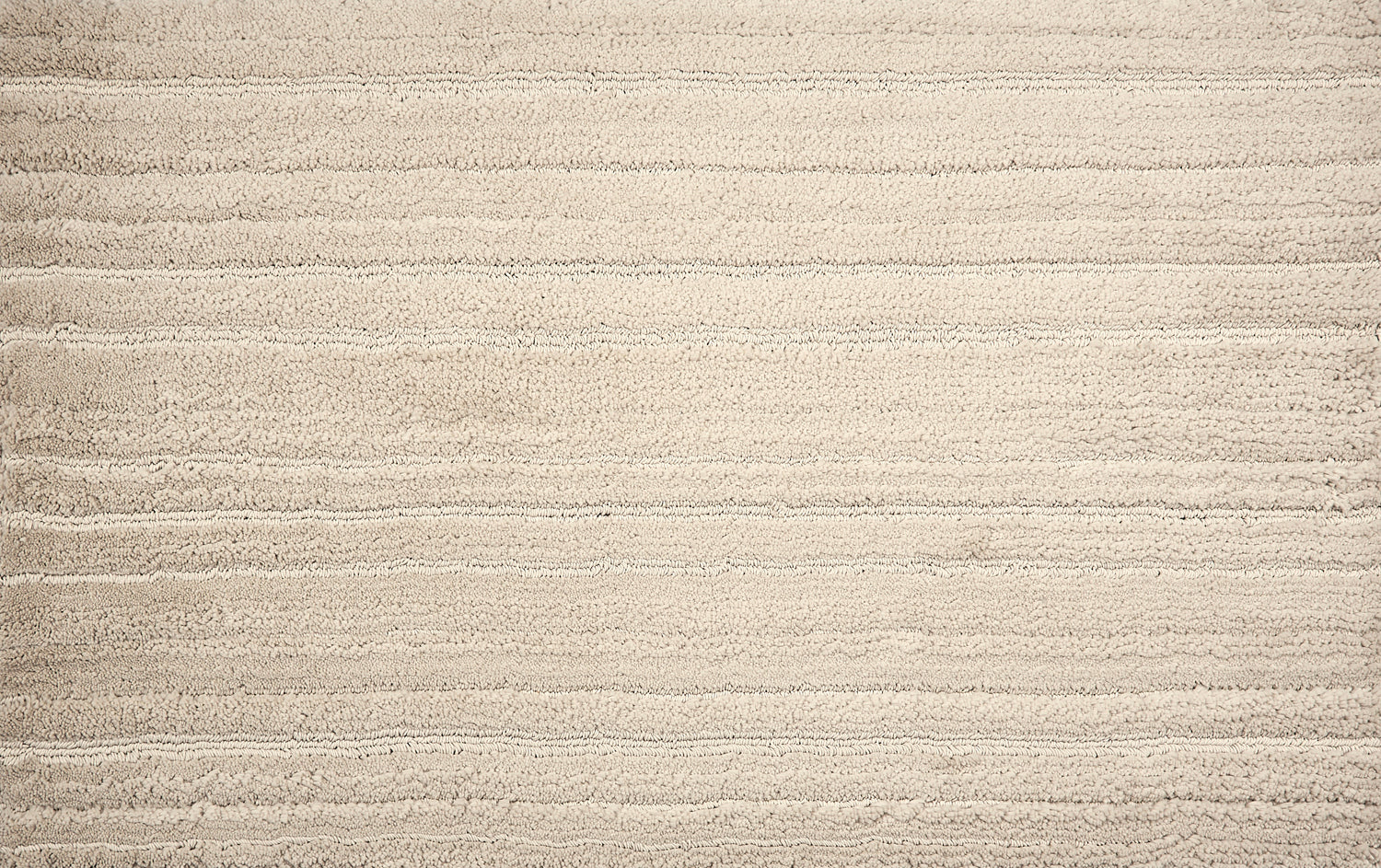 Broadloom carpet with ribbed and cut pile stripe in ivory.