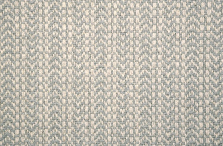 Broadloom carpet swatch in a herringbone pattern in a light blue design