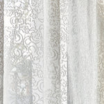 Draped sheer fabric in lace inspired botanical pattern in ivory.