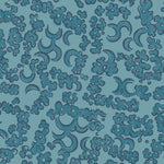 Wallpaper detail in a painterly botanical lace pattern in tonal shades of marine blue.