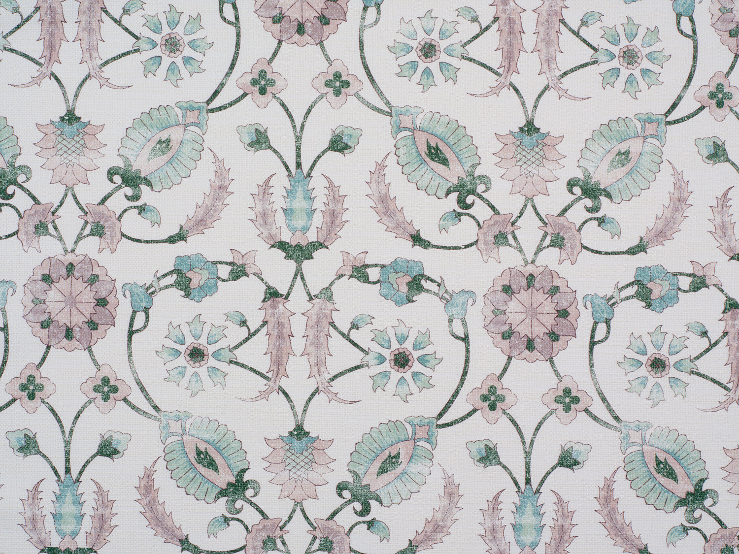 Detail of fabric in a floral paisley print in shades of pink and green on a cream field.