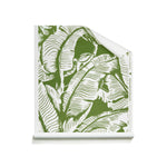 A roll of wallpaper with a green and white tropical banana leaf pattern, shown partially unrolled on a clean white background.