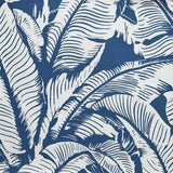 Close up of wallpaper with bold high contrast tropical banana leaf pattern in white on blue.