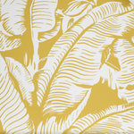 Close up of wallpaper with bold high contrast tropical banana leaf pattern in white on yellow.