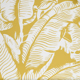 Close up of wallpaper with bold high contrast tropical banana leaf pattern in white on yellow.