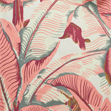 Close up of banana leaf pattern wallpaper featuring large tropical leaves in terracotta pink, cream, and muted gray-green tones on a light cream background.