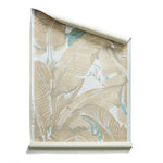 Roll of Banana leaf pattern wallpaper in beige, white, and light blue.