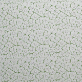 Fabric in a minimal floral print in purple and green on a gray field.