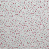 Fabric in a minimal floral print in pink and navy on a light gray field.