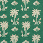 Detail of fabric in a playful palm tree print in white and brown on a green field.