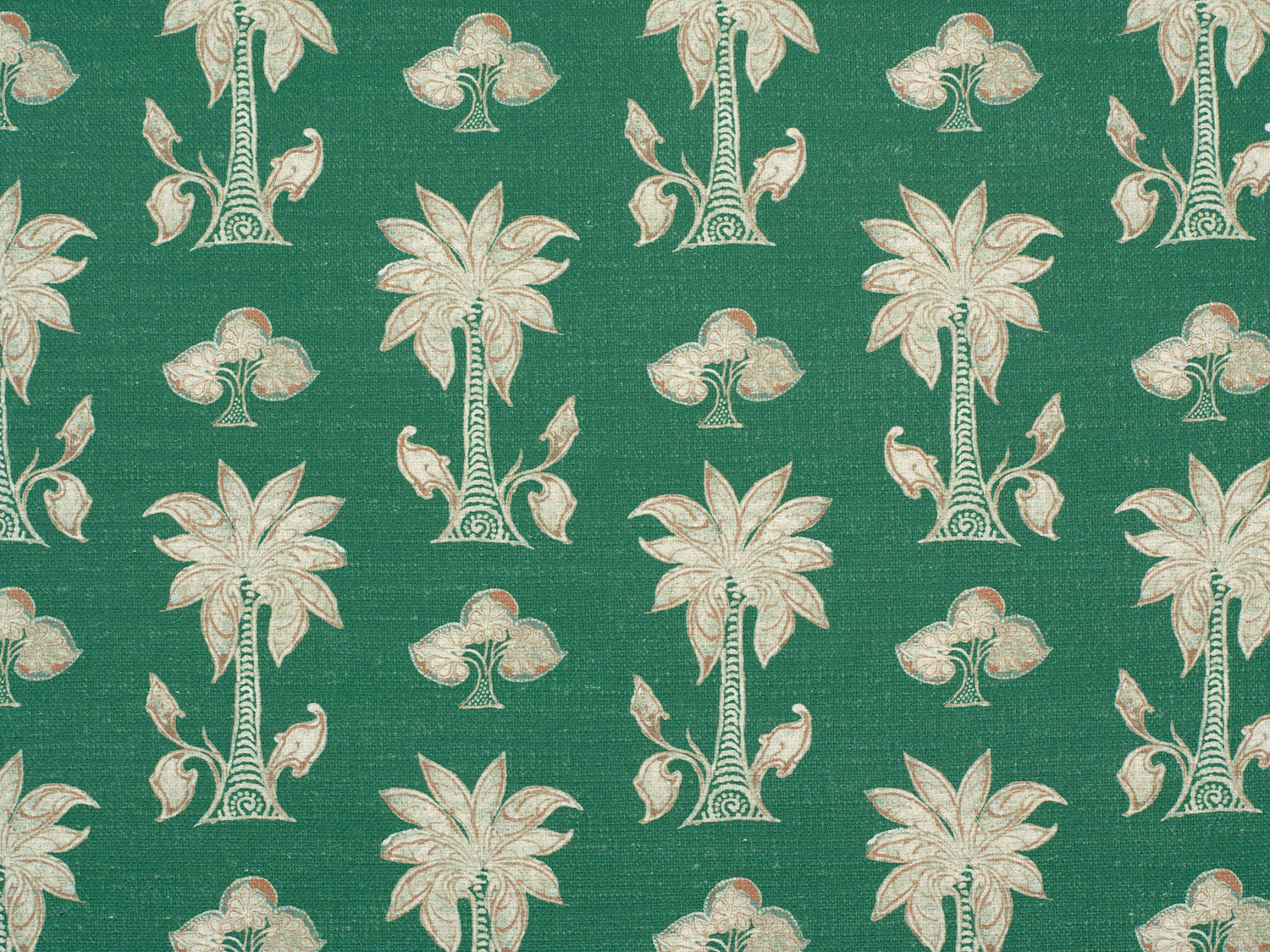 Detail of fabric in a playful palm tree print in white and brown on a green field.