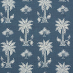 Detail of fabric in a playful palm tree print in white and navy on a blue field.