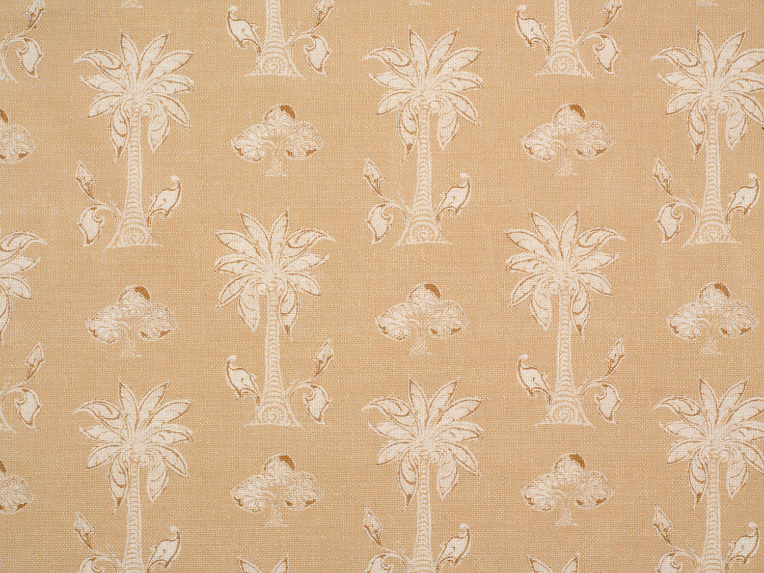 Detail of fabric in a playful palm tree print in tan and white on a light yellow field.