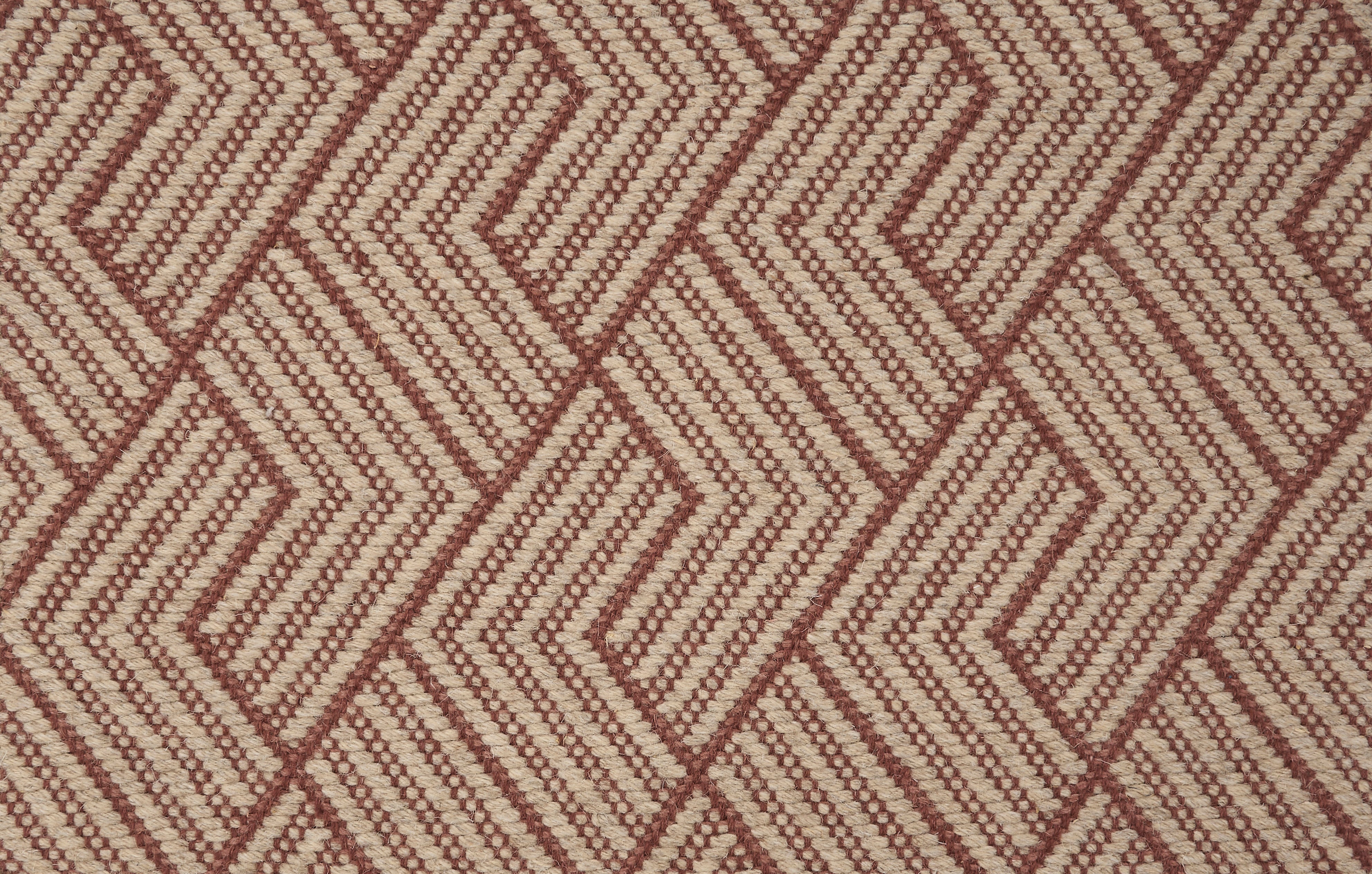 Broadloom carpet in a novel herringbone design in taupe and crimson