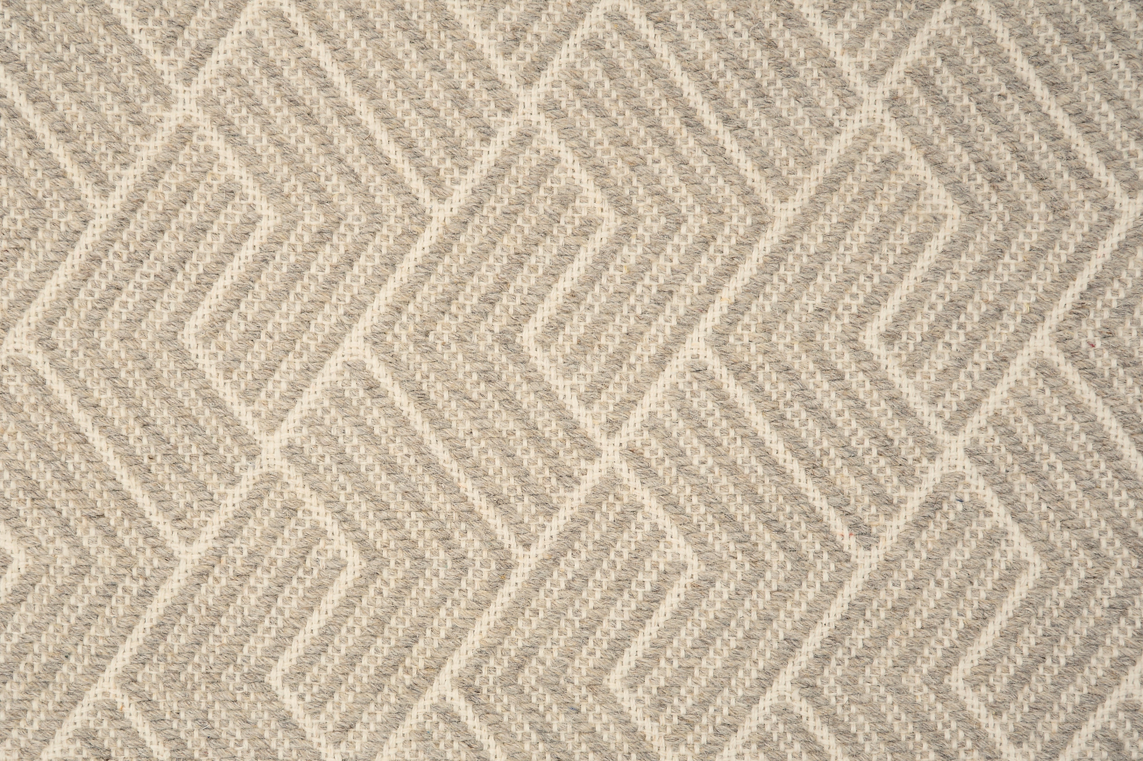 Broadloom carpet in a novel herringbone design in natural and cream