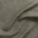 Detail of gently draped printed fabric with a white celestial dotted pattern on a muted sage green background. 