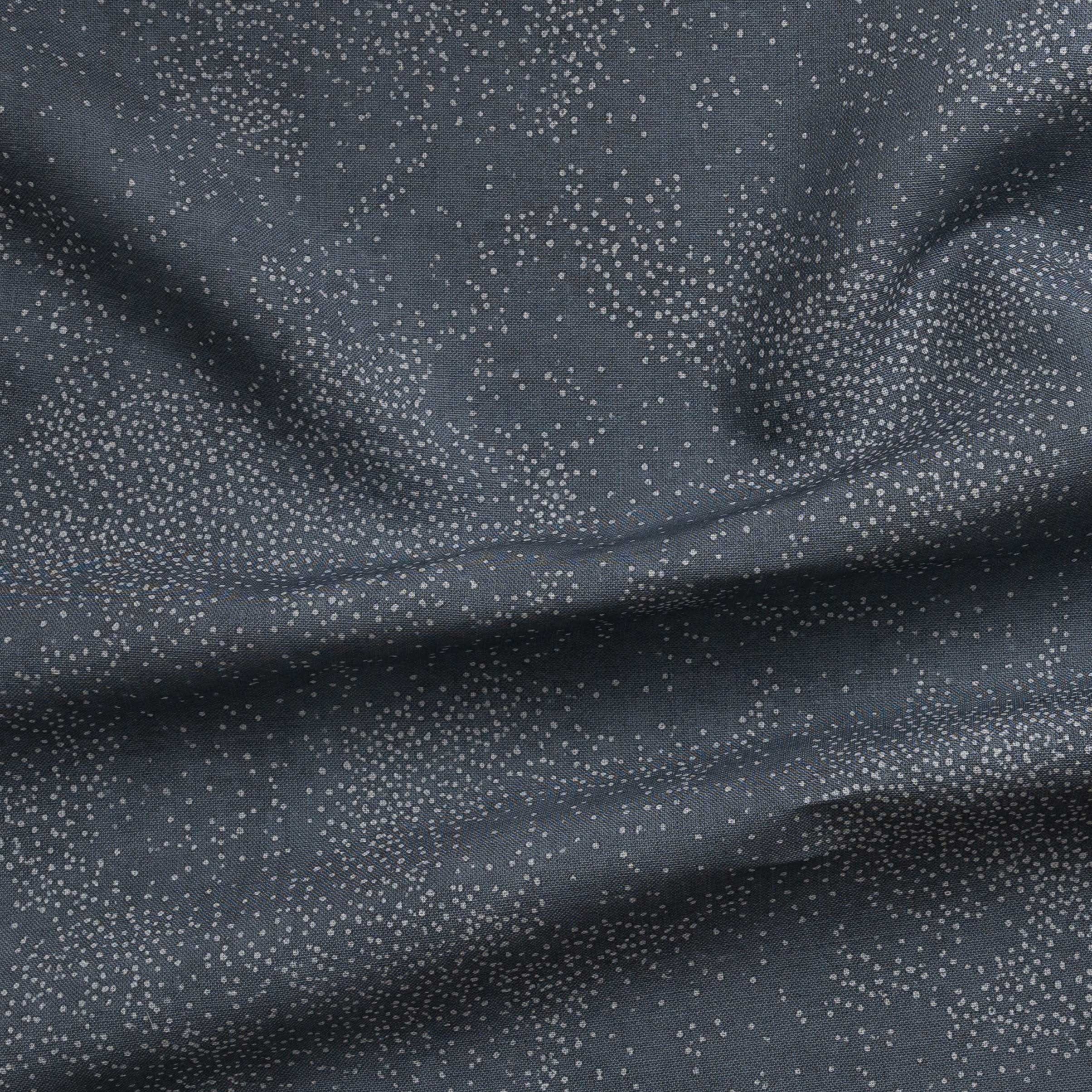 Detail of gently draped printed fabric with a white celestial dotted pattern on a cool blue background.