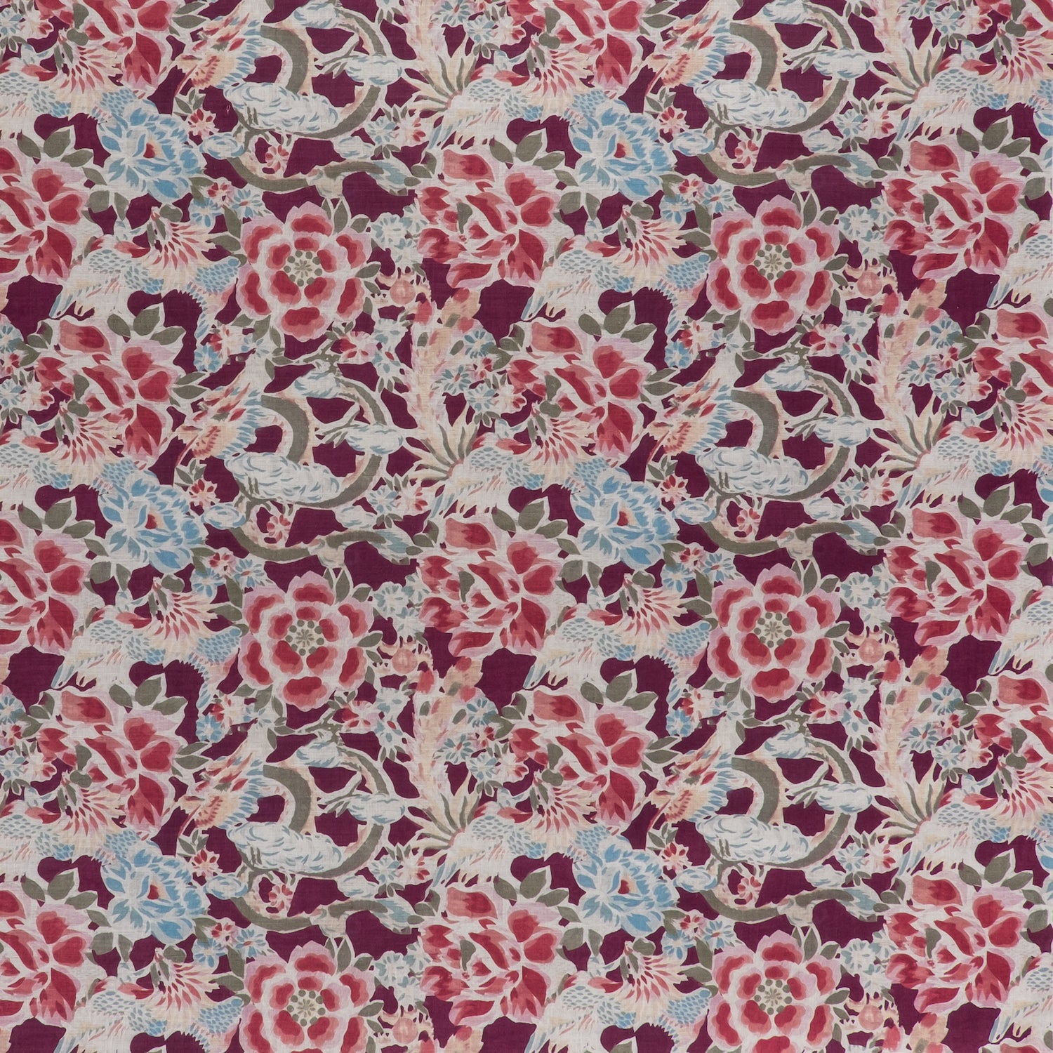 printed linen fabric in a painterly floral pattern in shades of blue, green and pink on a maroon field.