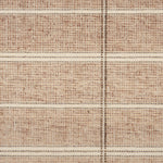 Broadloom carpet in large scale plaid in shades of rust and brown.