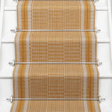 Striped flatweave runner in orange on white staircase 