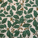 Pattern of green leaves and acorns on a beige background
