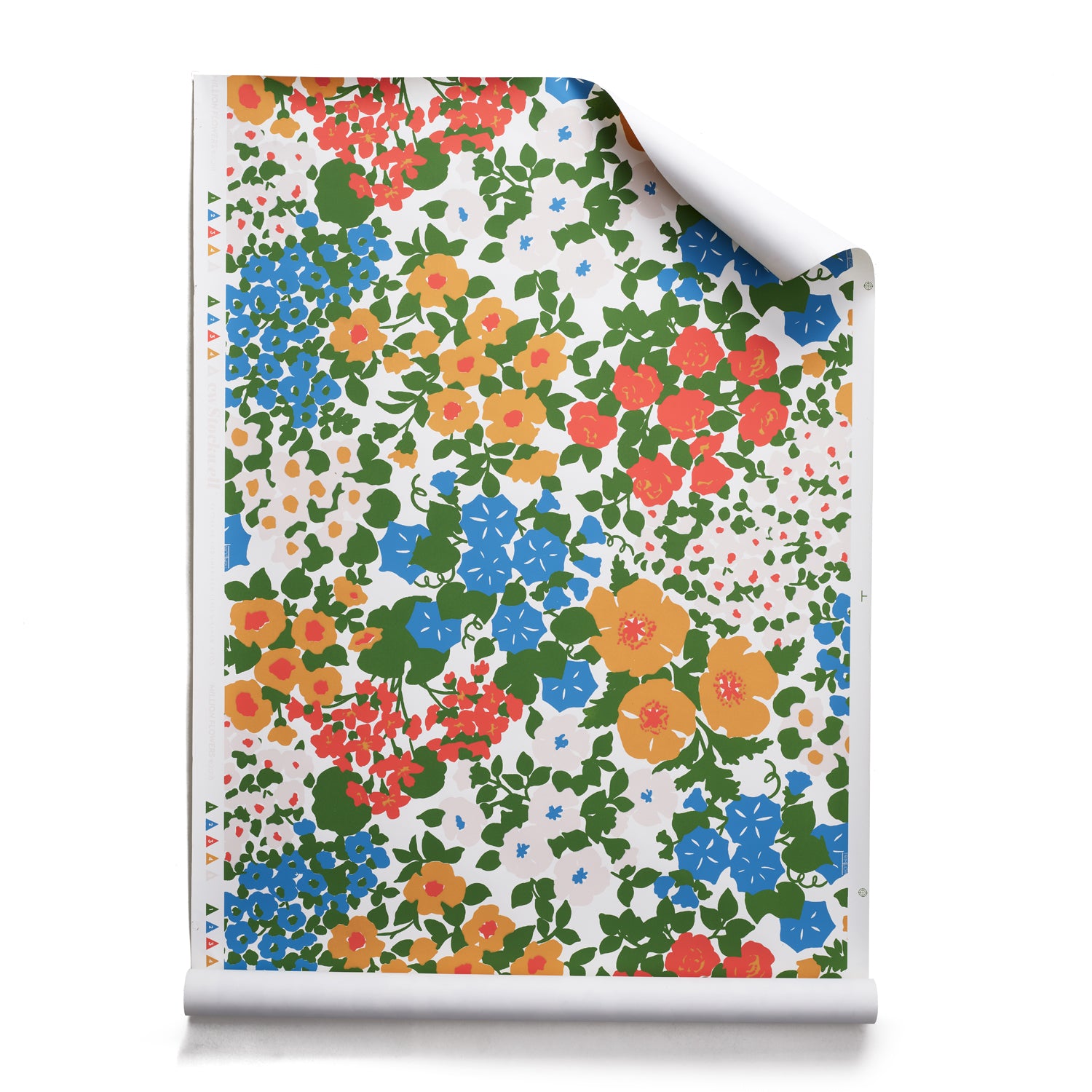 A roll of wallpaper with a dense flower and leaf pattern in shades of  yellow, orange, blue, green and white. 