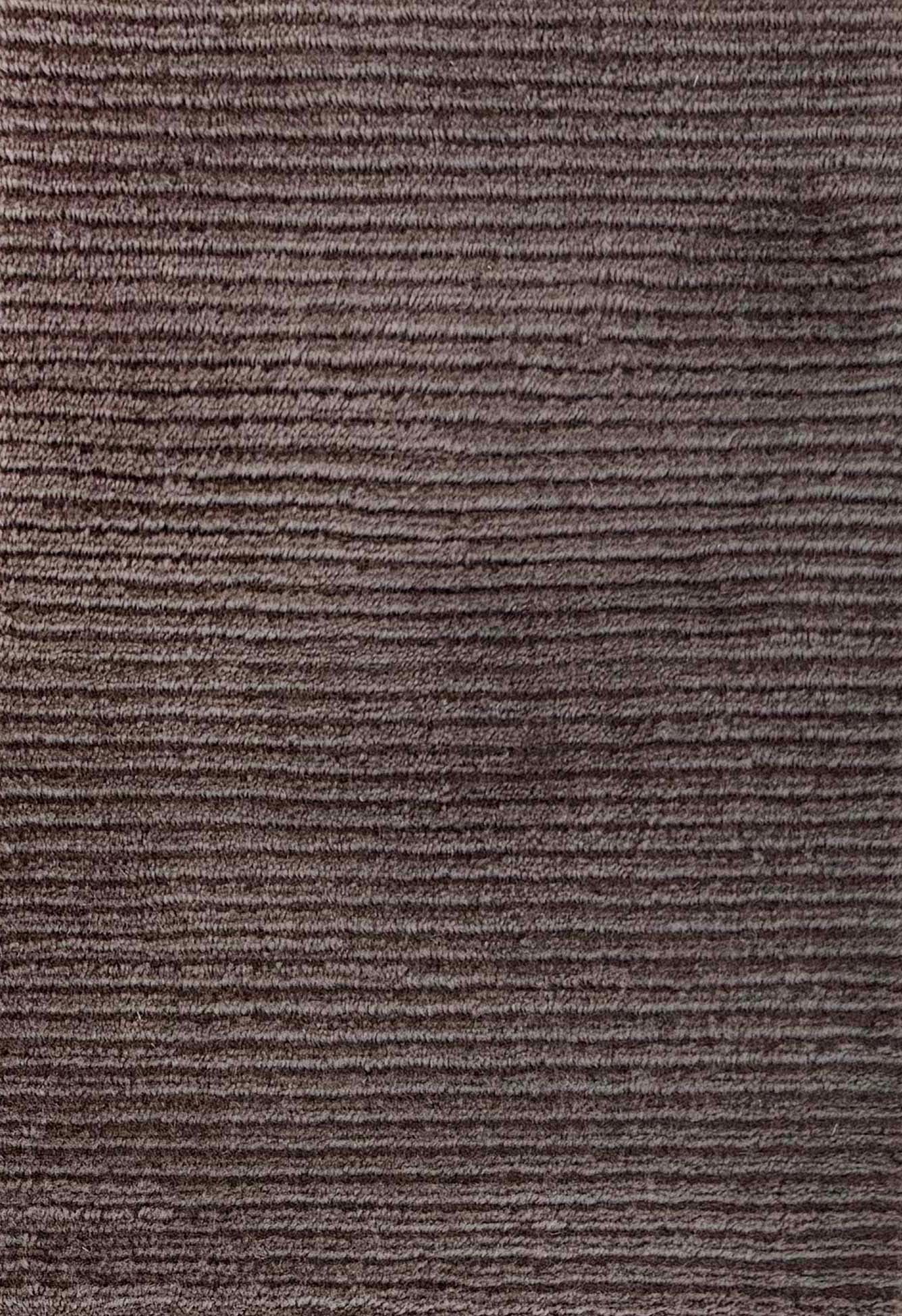 Close up of broadloom carpet with solid cut pile ribbed stripe in dark brown.