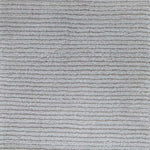 Close up of broadloom carpet with solid cut pile ribbed stripe in grey.