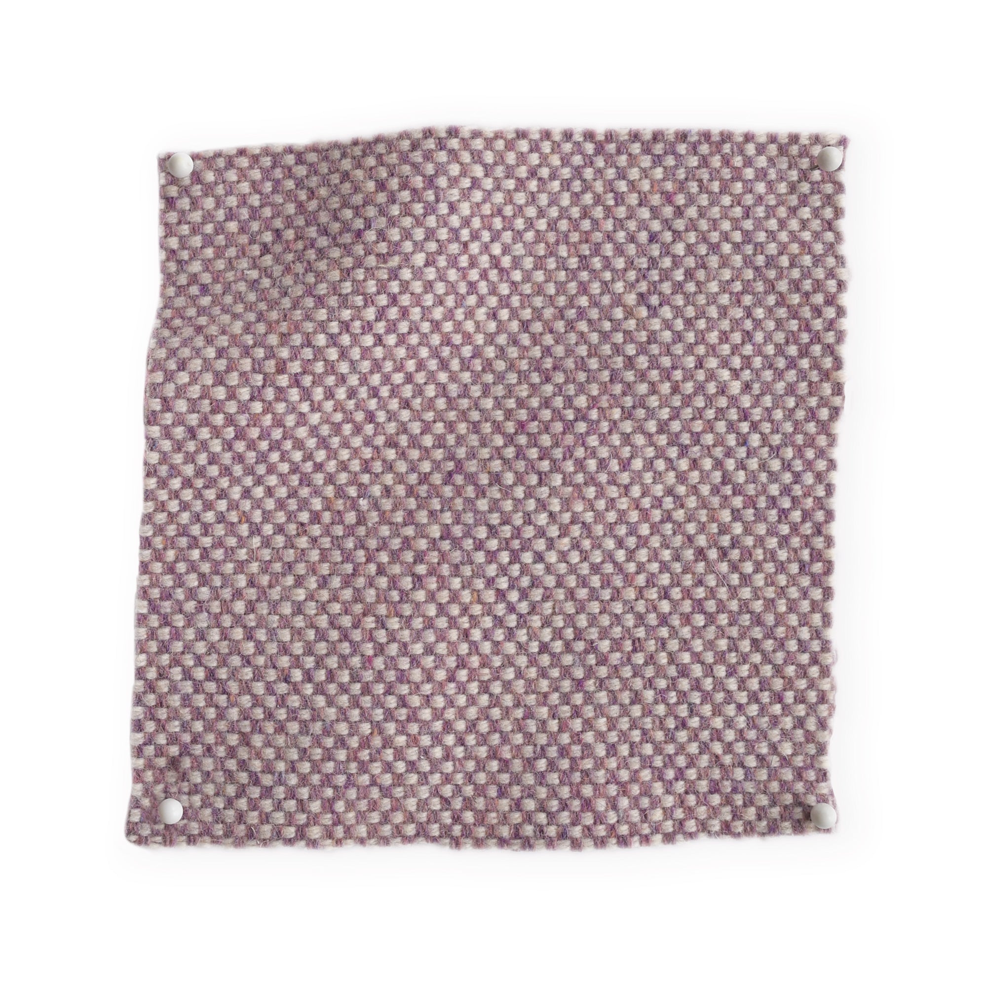 Pinned swatch of woven fabric in pale purple. 