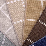Broadloom carpet samples in plaid pattern in blue, tan, beige, brown and blue.