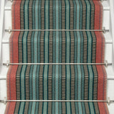 Striped flatweave runner in red blue and green black on white staircase