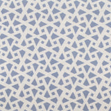 Detail of fabric in a geometric lattice print in blue on a cream field.
