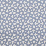 Detail of fabric in a geometric lattice print in blue on a cream field.