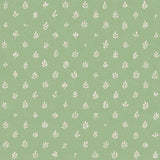 Detail of fabric in a repeating leaf print in cream on a green field.