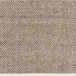 Detail of a flatwoven rug, with a brown and white twill design
